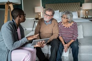 A couple talk with a nurse about their in-home recovery support plan.