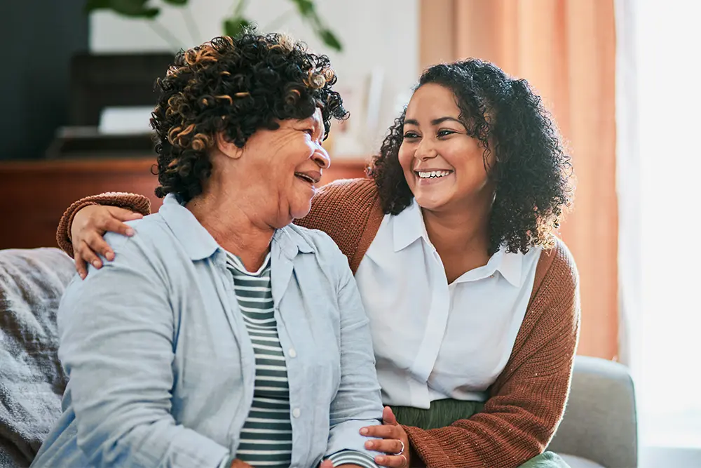 Companion Care in the Greater Burlington Area A woman receiving companion care services in Burlington shares a laugh with her caregiver.