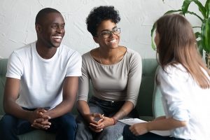 A couple receiving elder mediation for families smile together.