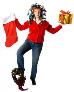 Woman balancing holiday decorations with hands and feet