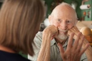 Senior man listening to family caregiver